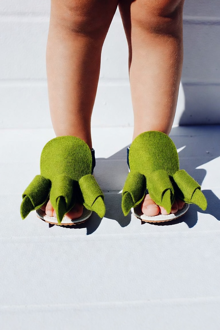 DIY dinosaur feet made from green felt claws worn over a child's shoes