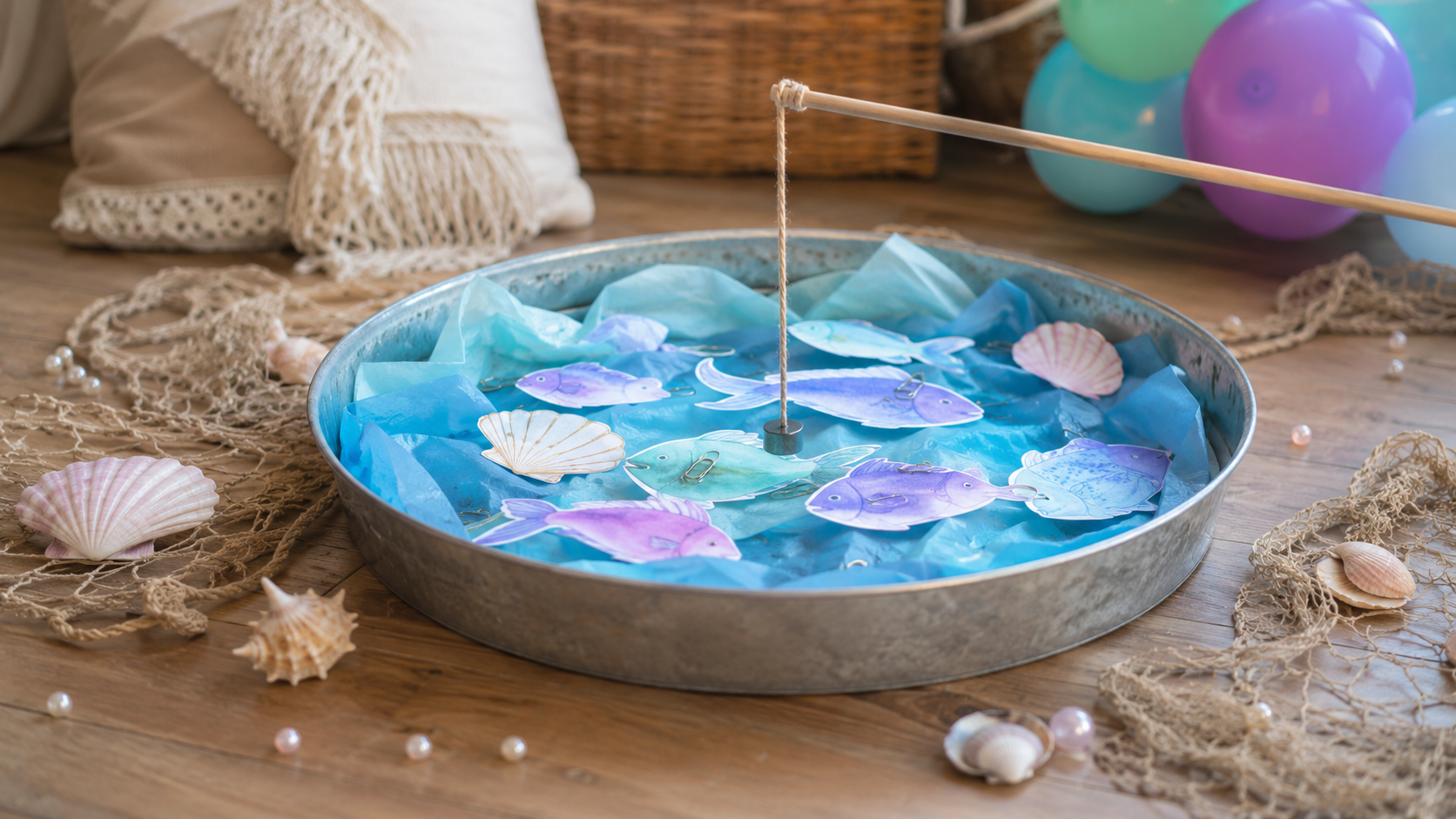 Mermaid pearl diving game with paper fish in a metal tray