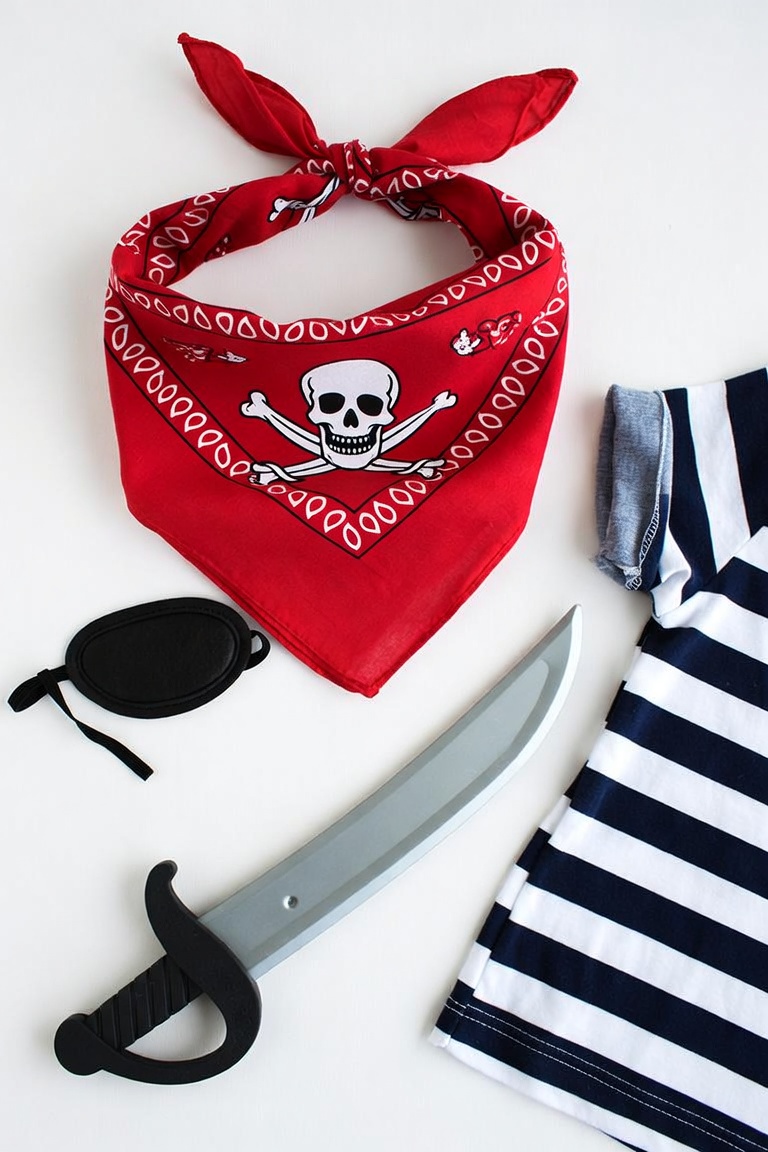 DIY pirate costume with red skull bandana, eye patch, foam sword and striped shirt